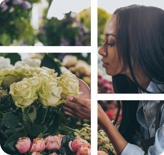 A florist bends down to smell cut white roses.