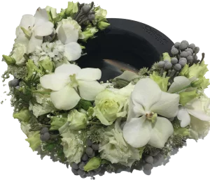 A white wreath arrangement made with OASIS® Black Floral Foam.
